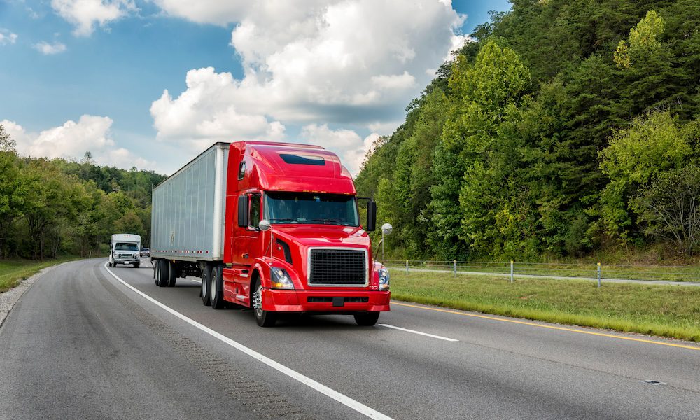 Red semi truck on an interstate highway